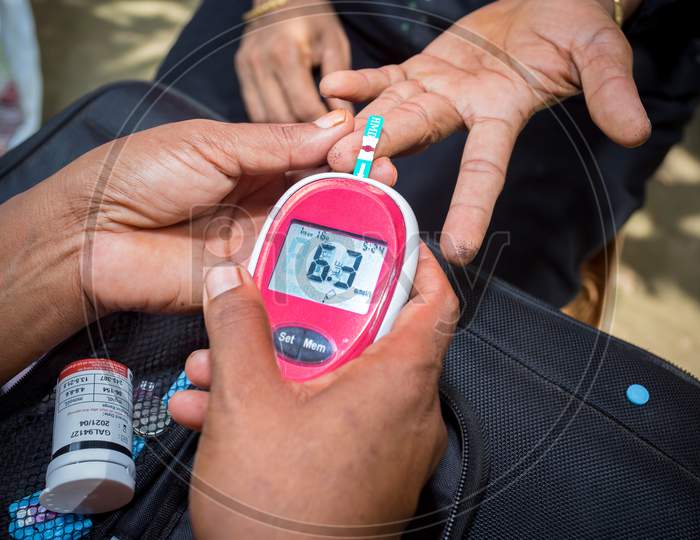 Doctor Checking Patient For Diabetes or Blood Sugar With a Glucose meter Closeup