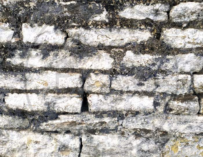 Old Wall with Moldy Peeling White Painting from Humidity. Cracked White Wall as Rusty Concrete Weathered Wall Grunge Background