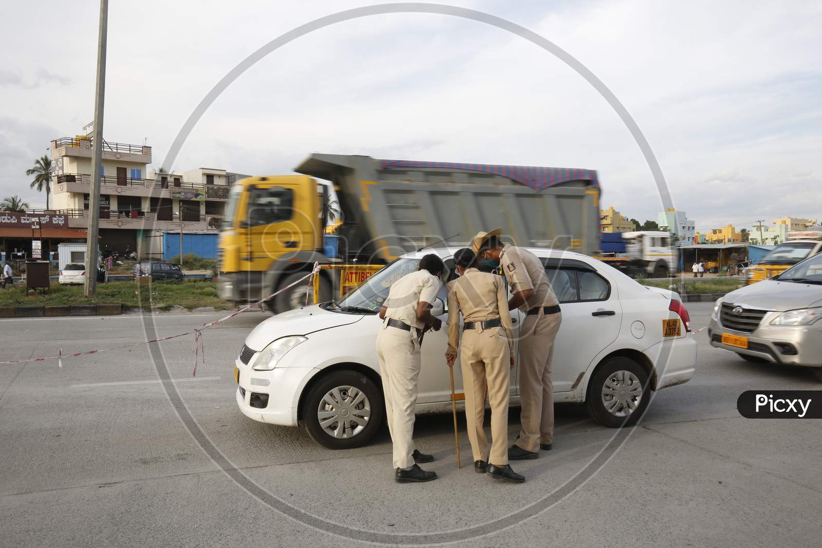 Police personnel check papers of people travelling at a check post during the nationwide lockdown to stop the spread of coronavirus (Covid-19) in Bangalore, India.