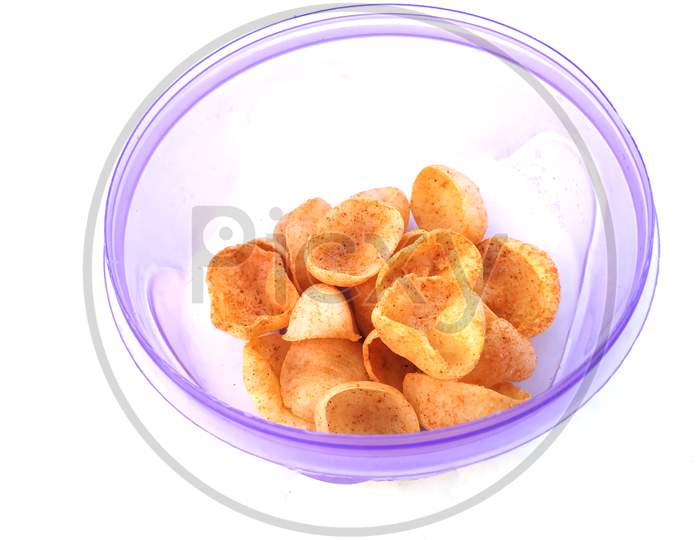 some yellow eatable food put in blue plastic bowl isolated on white background