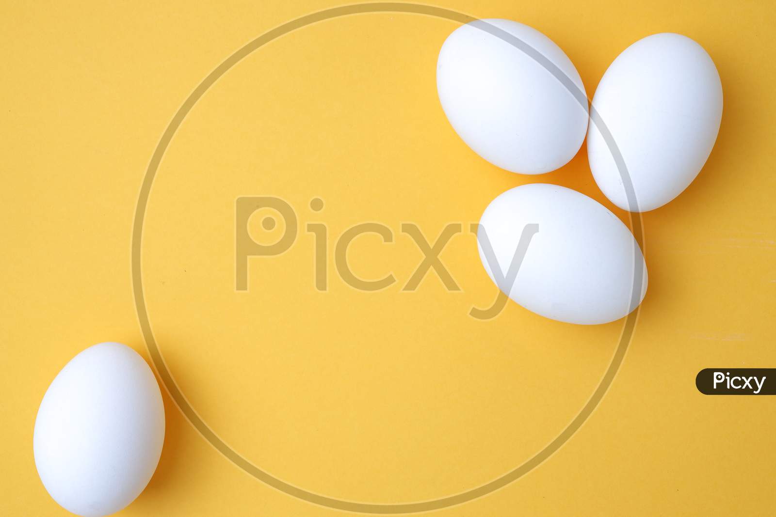 Eggs,Three White Egg On The Yellow Background In Center,Copy Space For The Ads