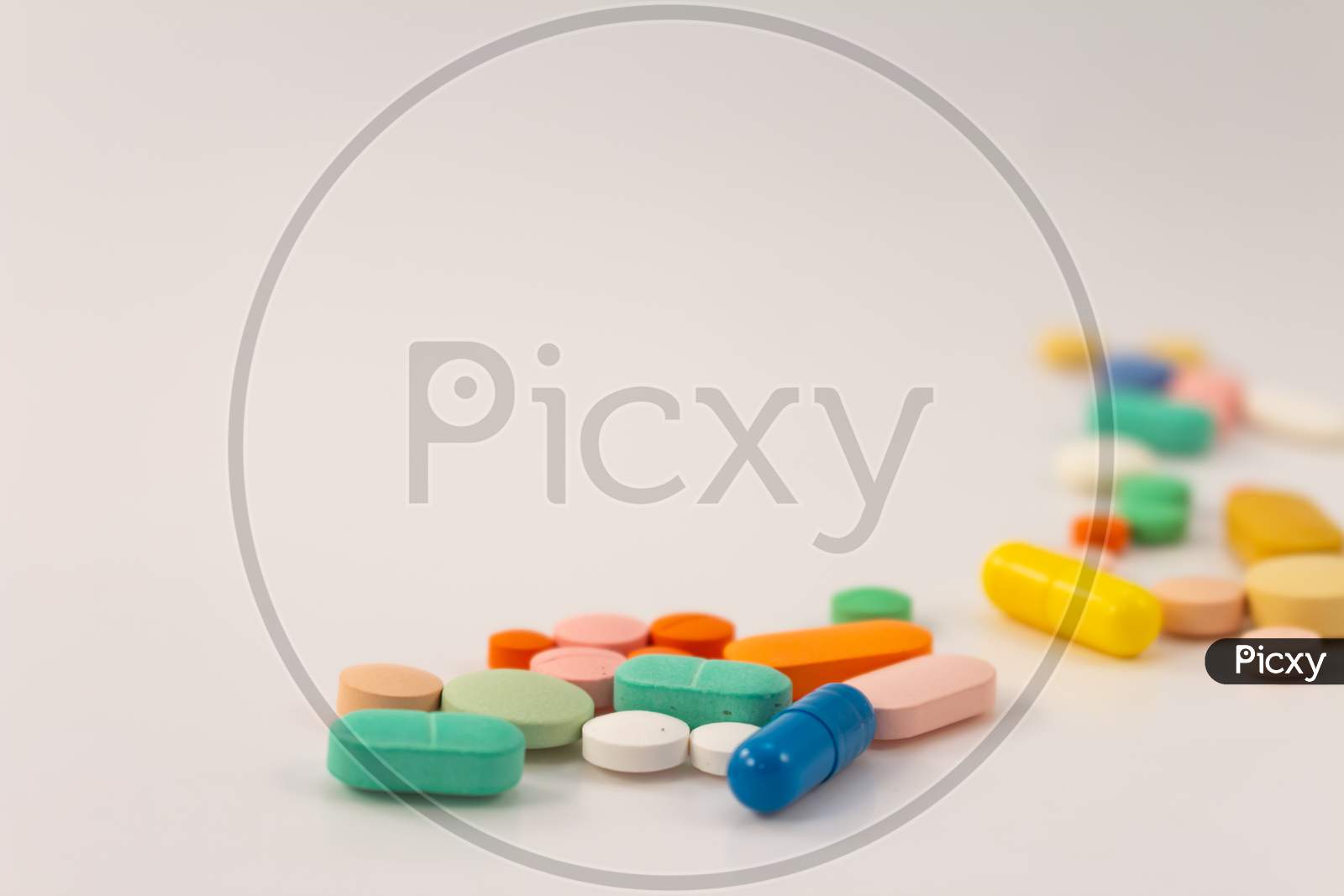 Drugs In The Form Of Medicines. Capsules And Tablets Of Various Colors And Shapes For Human Use. Pharmaceuticals On White Background.