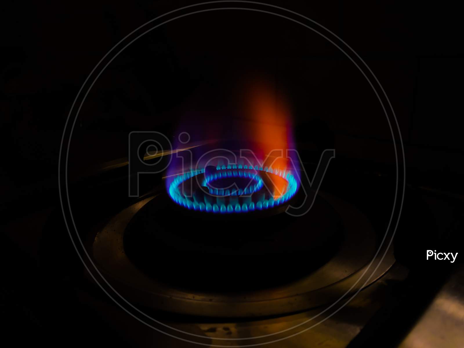 Isolated Blue Flame With Orange Shade Of Gas Burner At Black Background