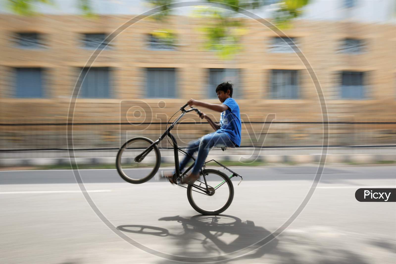 A boy rides a bicycle on an empty street during the nationwide lockdown to stop the spread of coronavirus (Covid-19) in Bangalore, India.