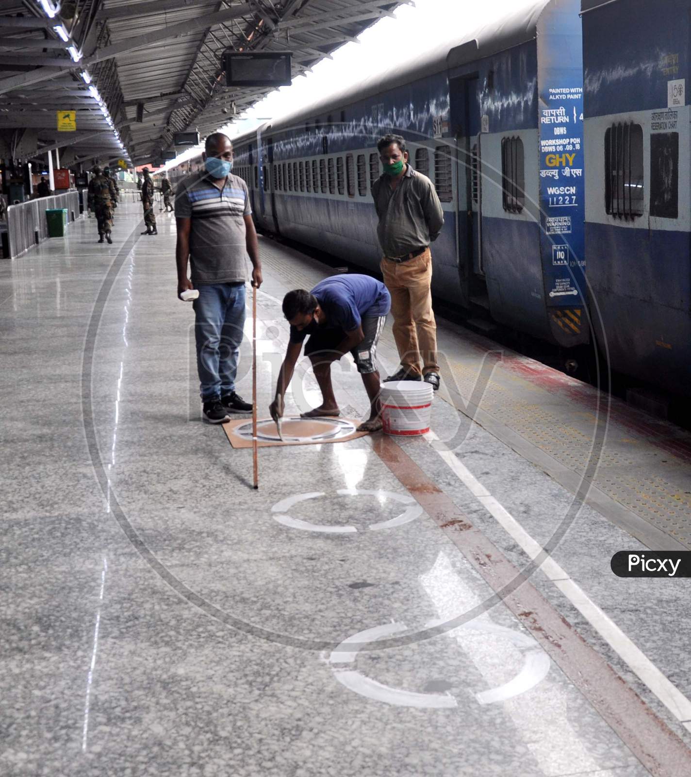An Employee Marking Circles On A Railway Platform To Maintain Social Distance At Guwahati Railway Station During Nationwide Lockdown Amidst Coronavirus Or Covid- 19 Pandemic, In Guwahati On May 13, 2020.