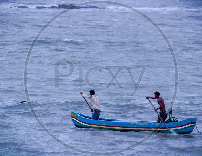 Two Fishermen Are Fishing In The Arabian Sea In Mumbai, India. Wide Angle Shot