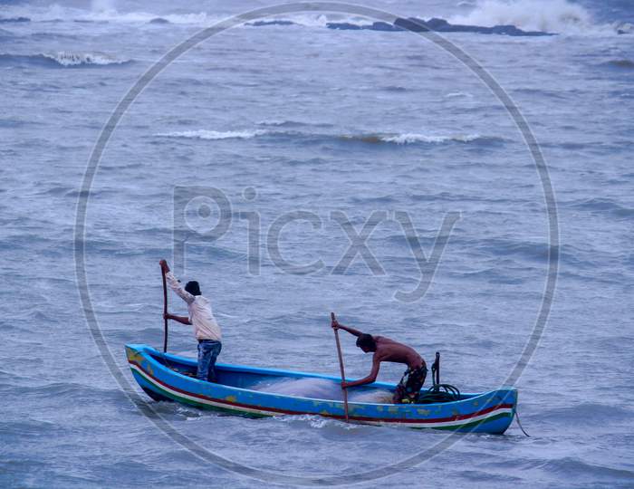 Two Fishermen Are Fishing In The Arabian Sea In Mumbai, India. Wide Angle Shot