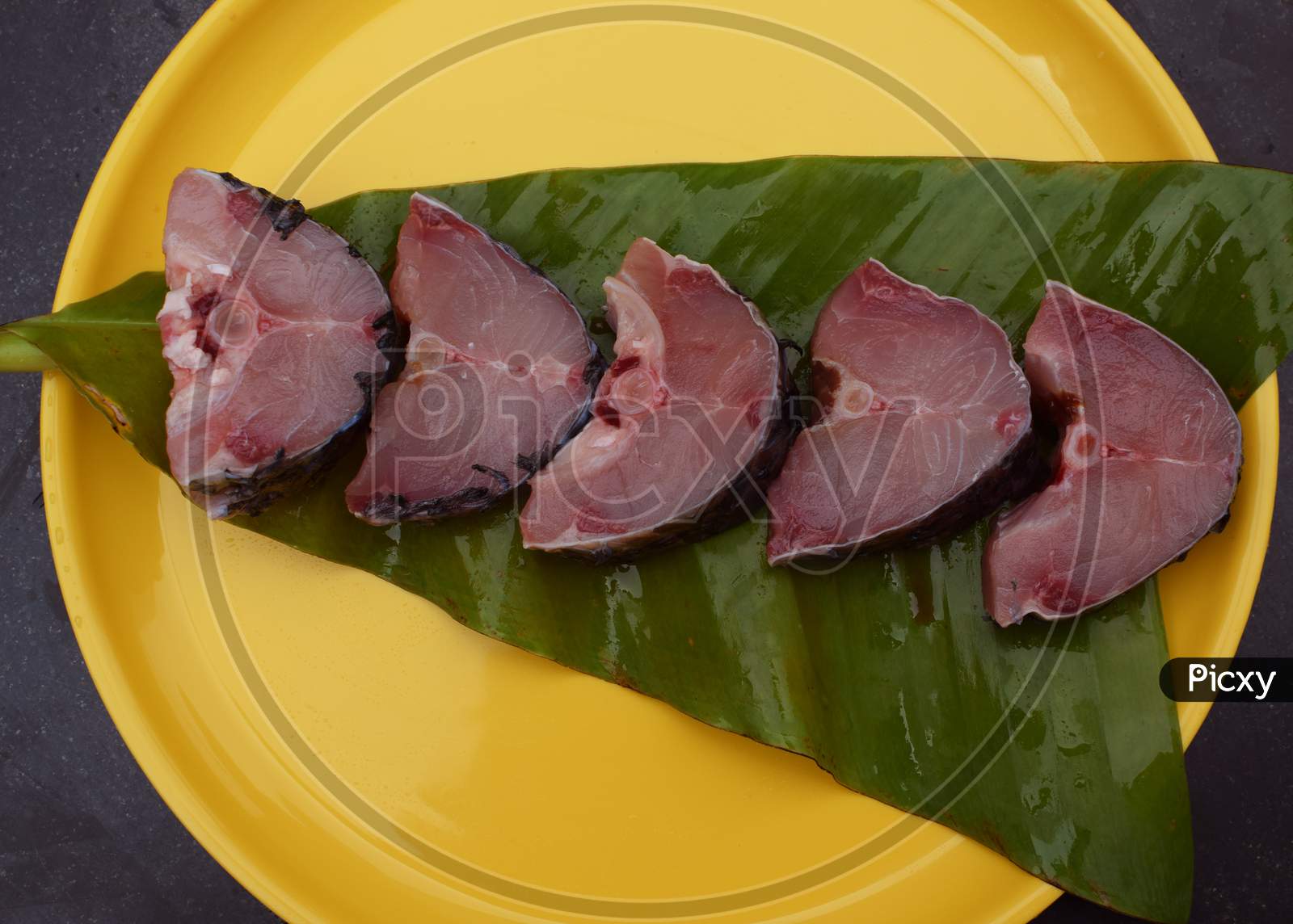 Raw fish Steaks of Rohu fish Labeo Rohita over banana leaf