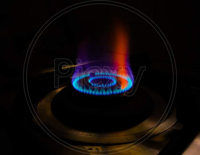 Isolated Blue Flame With Orange Shade Of Gas Burner At Black Background