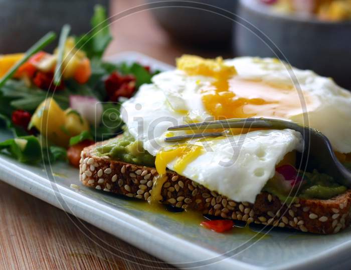 Delicious Tasty Poached egg with bread and salad for breakfast