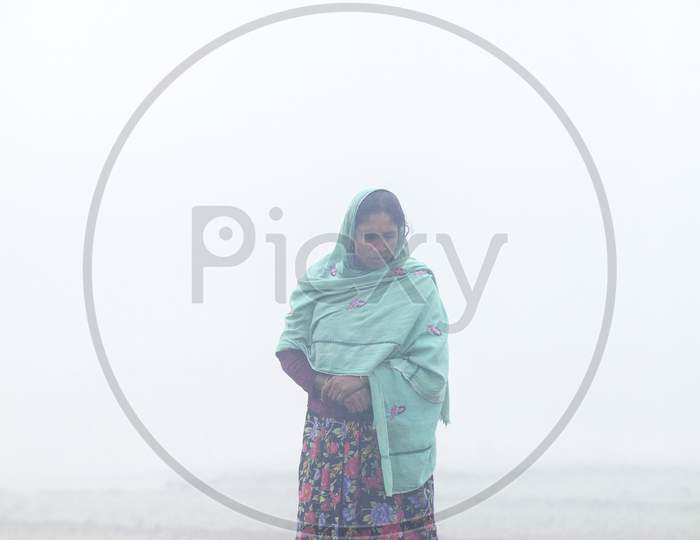 Bangladesh – January 06, 2014: On A Foggy Winter Morning, A Woman Is Working On Her Land At Ranisankail, Thakurgaon.