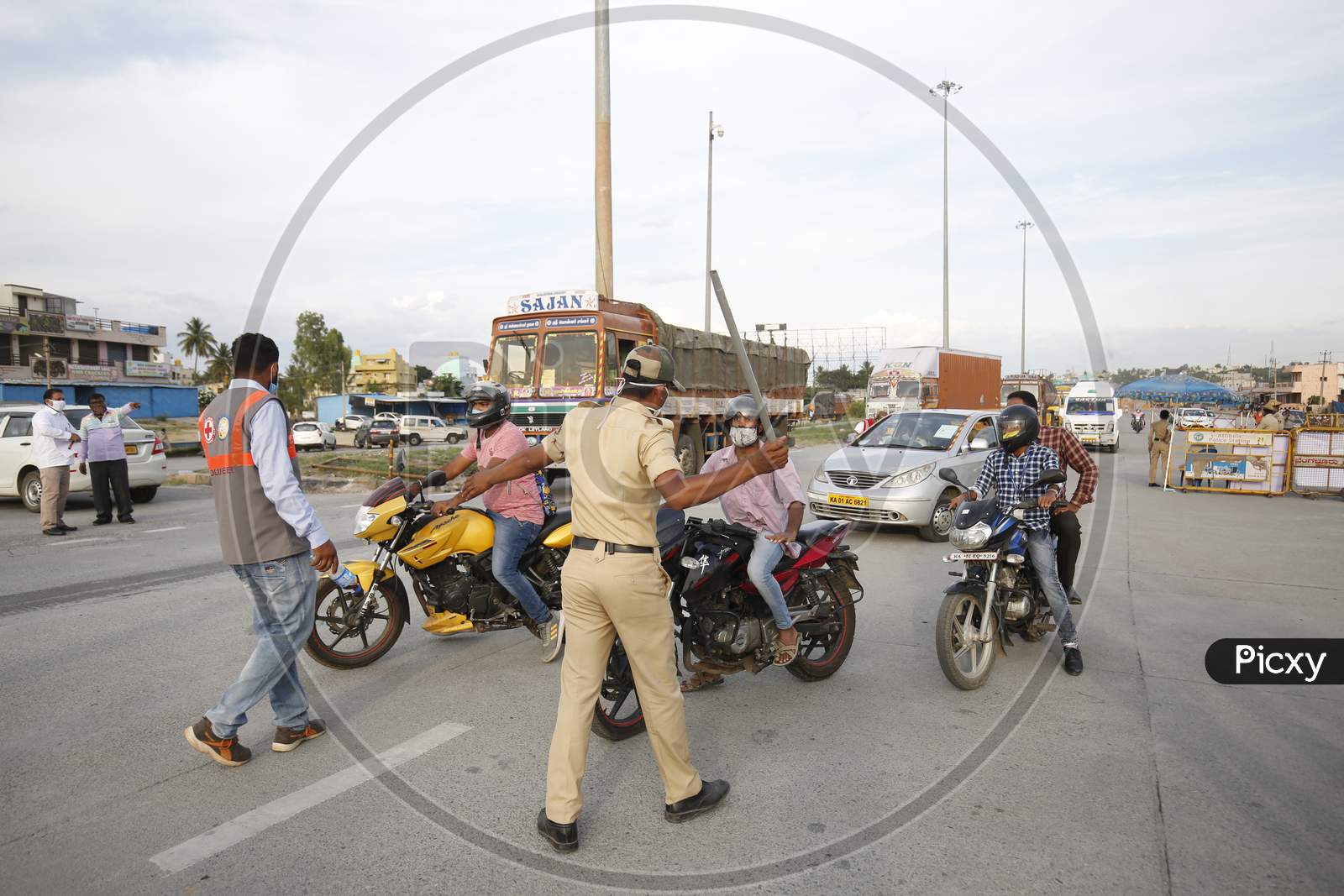 A police officer wields his baton at a check post during the nationwide lockdown to stop the spread of coronavirus (Covid-19) in Bangalore, India.