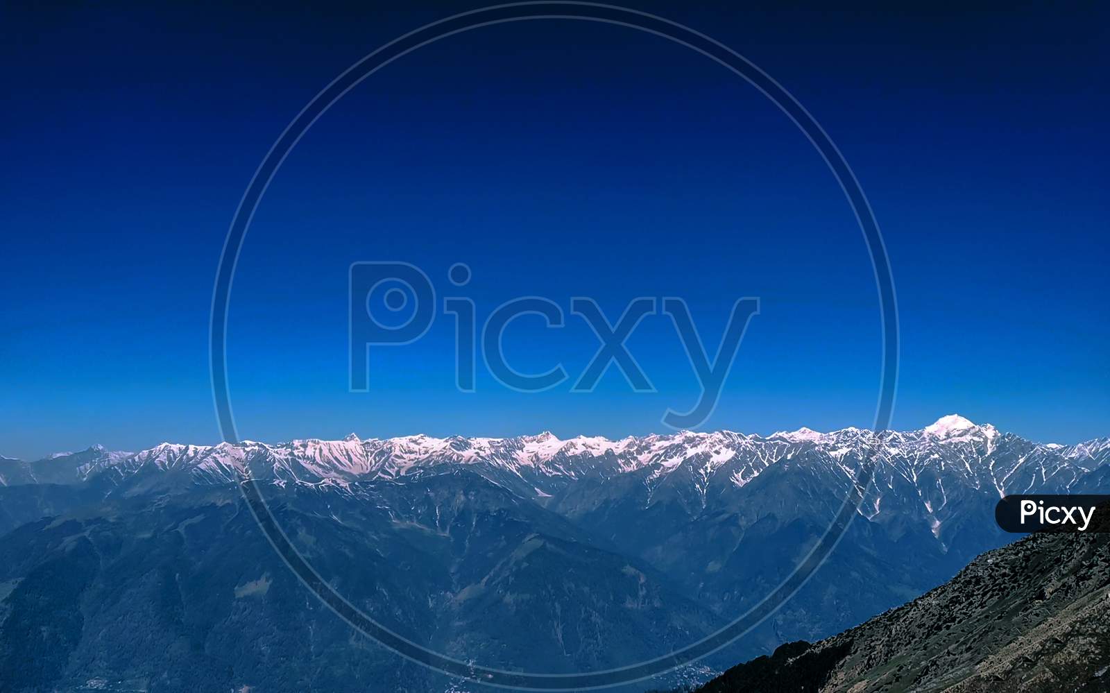 Himalaya A Snow Caped Mountain Range With Blue Sky.