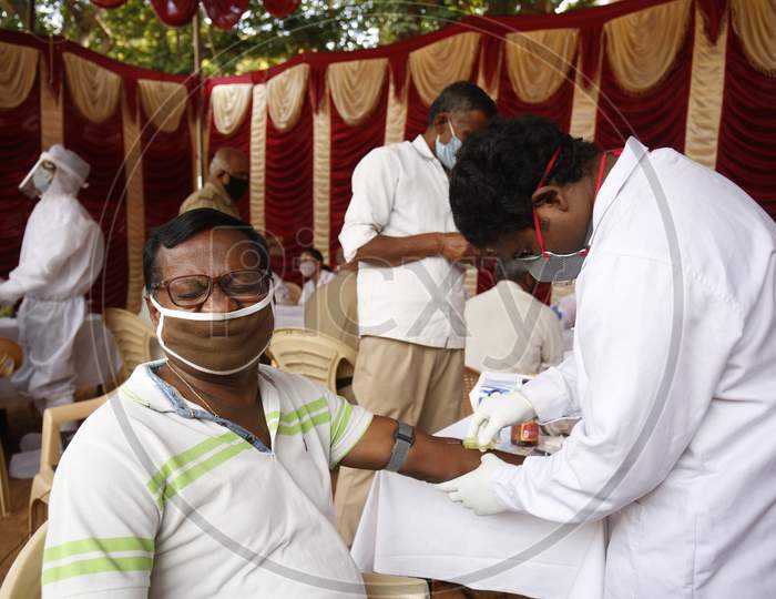 A police officer reacts as he gets a test done to check for covid-19 during a health screening camp for the police forces in Bangalore, India.