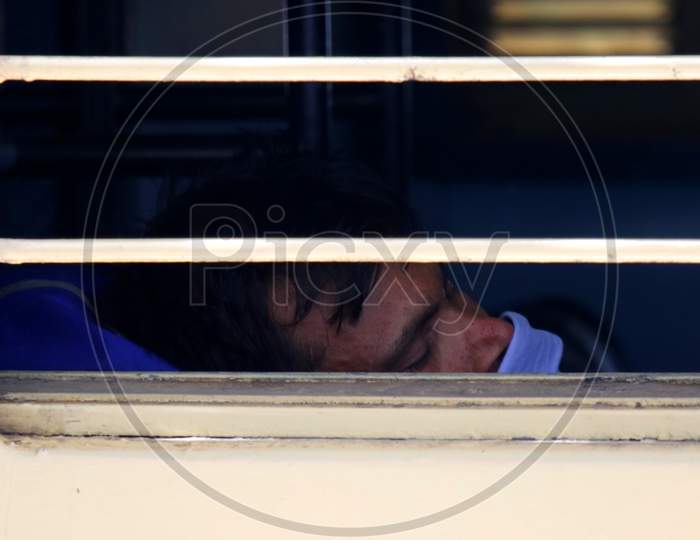  A Stranded migrant sleeps after boarding a special train to Bihar State from Ajmer railway station during a government-imposed nationwide lockdown as a preventive measure against the COVID-19 coronavirus, in Ajmer on May 13, 2020.