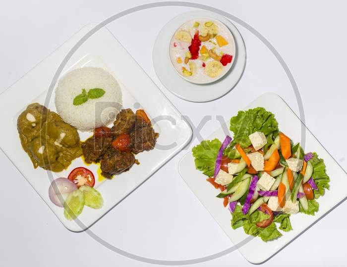 Asian Style Ramadan Sehri Food Set. Healthy Full Course Meal. A Plate Of Green Salad, A Plate Of Plane Rice And 2 Kind Of Beef Curry With Faluda Dessart On White Background.