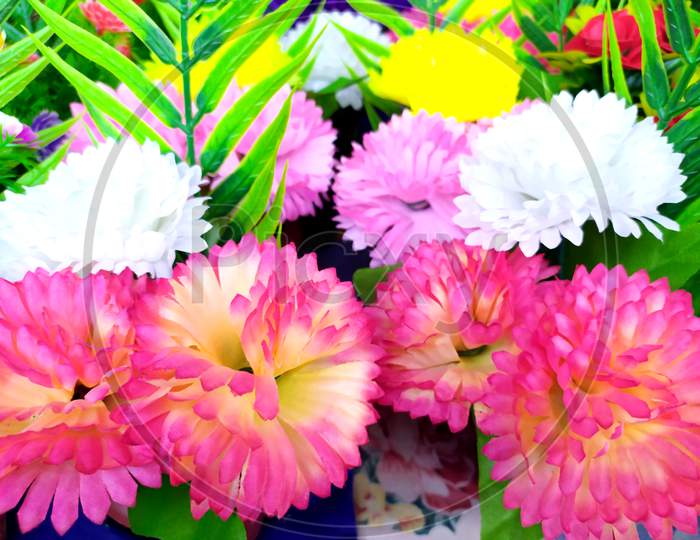 Beautiful cloth many multicolored artificial flowers background