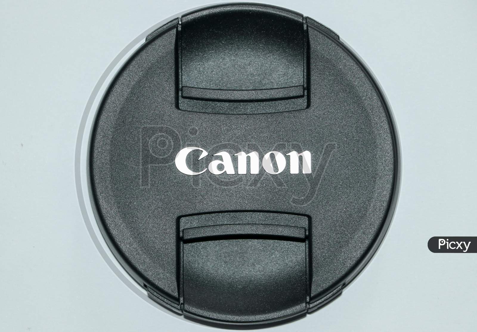 A lens cap of canon 18-135mm lens with white background