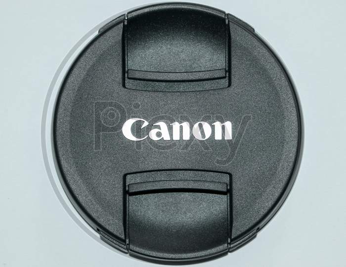 A lens cap of canon 18-135mm lens with white background