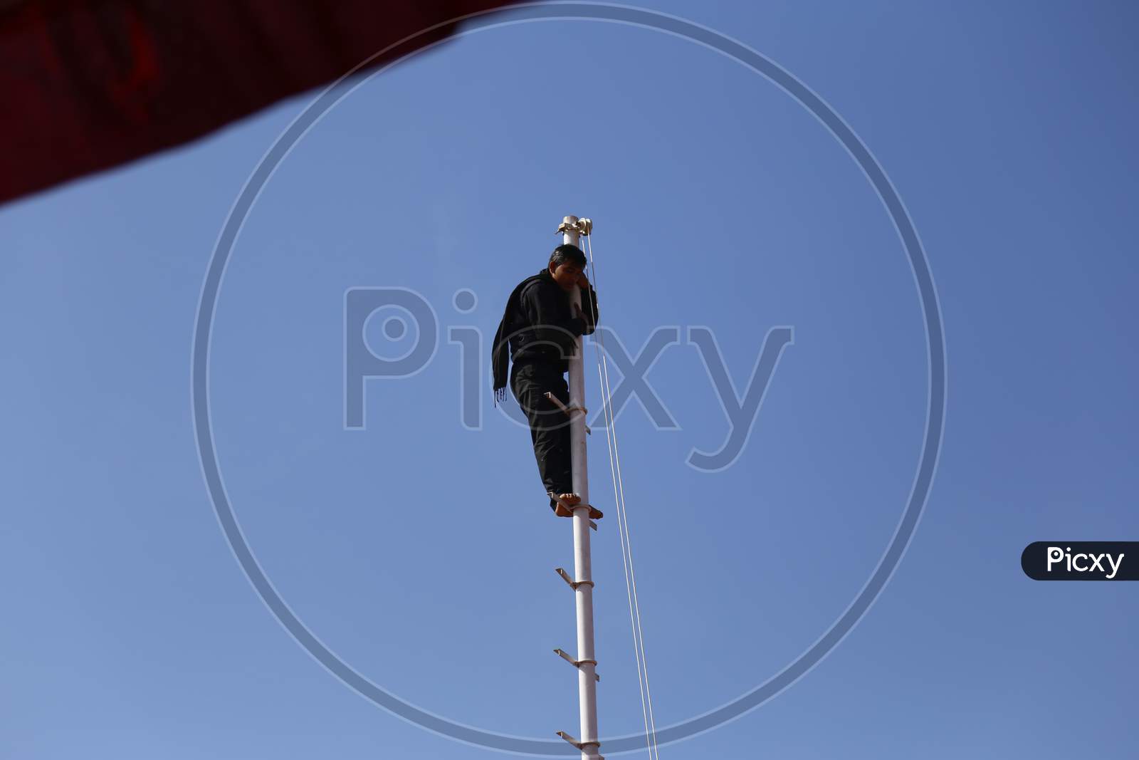 A Man Standing On Pole in Nagaur Cattle Fair