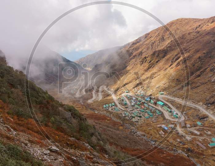 mountain valley landscape with military army bunker and hilly hairpin road to protect border