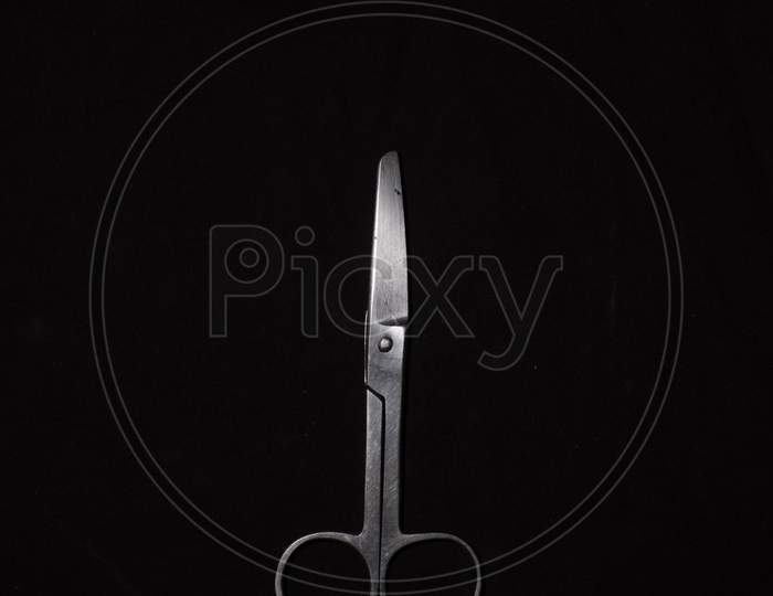 A Scissor In A Dark Copy Space Background. Product Photography.