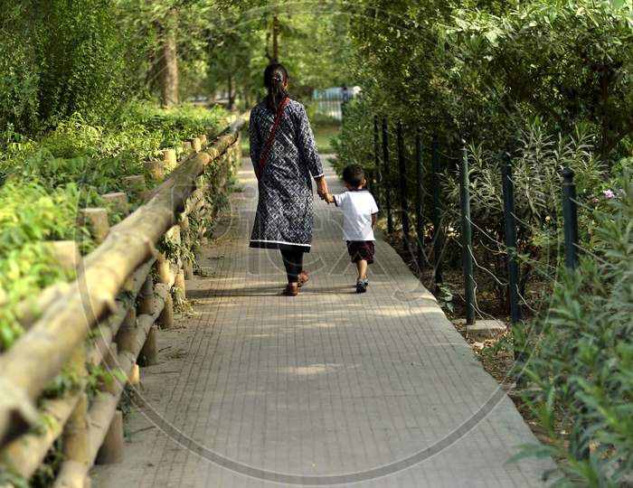 A Mother And Son Walking Hand In Hand At Delhi Zoo