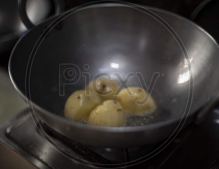 Potatoes Are Fried In Oil In A Large Cooking Pot In An Indian Kitchen. Indian Food And Kitchen.