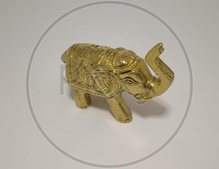 Statue of Golden metal elephant in white background