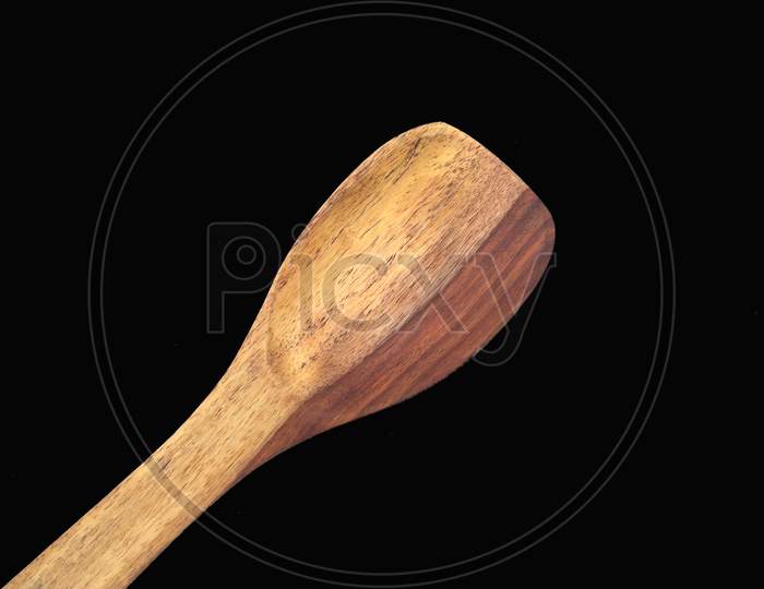 some wooden spatula isolated on black background