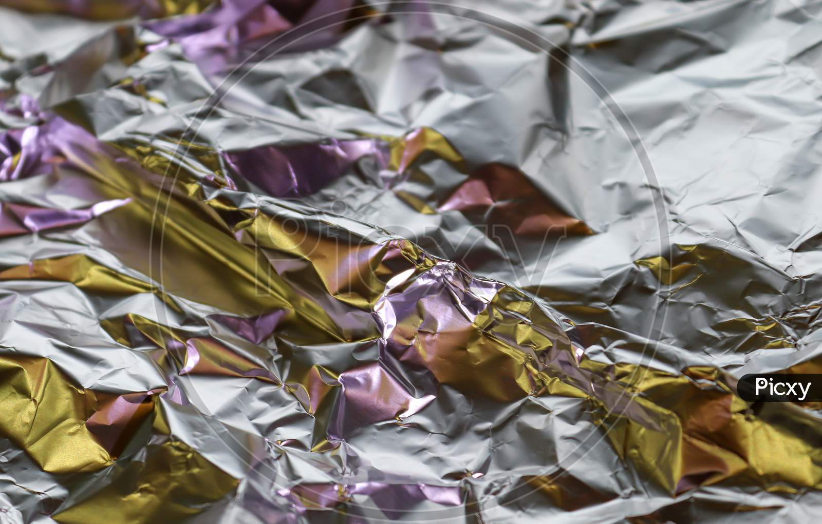 Detailed close up texture of an aluminum foil surface in different