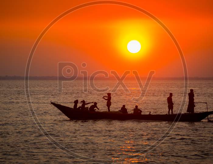 Colorful Golden Sunset On Sea. Fishermans Are Returning Home With Fish, Manually At Sunset On Char Samarj Beach At Chandpur, Bangladesh.