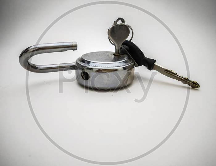 Steel Lock And Key Close Up Shot Isolated In White Background.