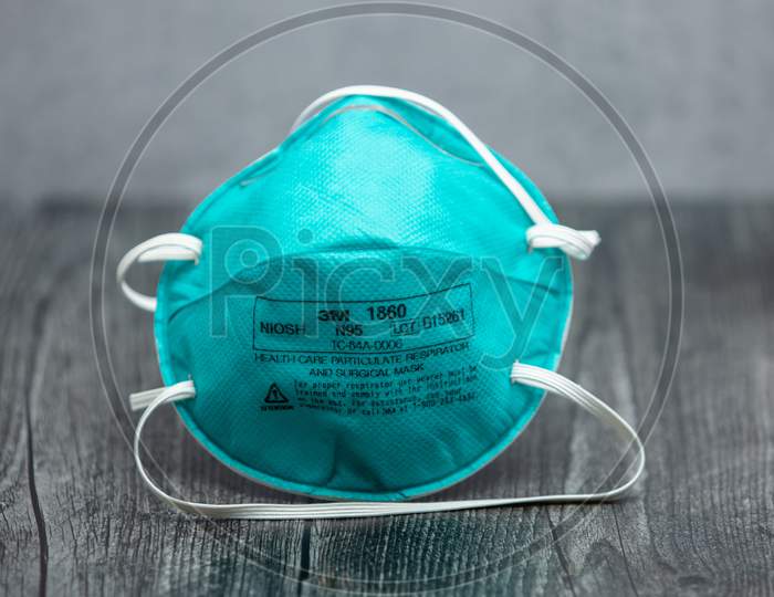 Turquoise 3M N95 Respirator Mask On Wooden Table