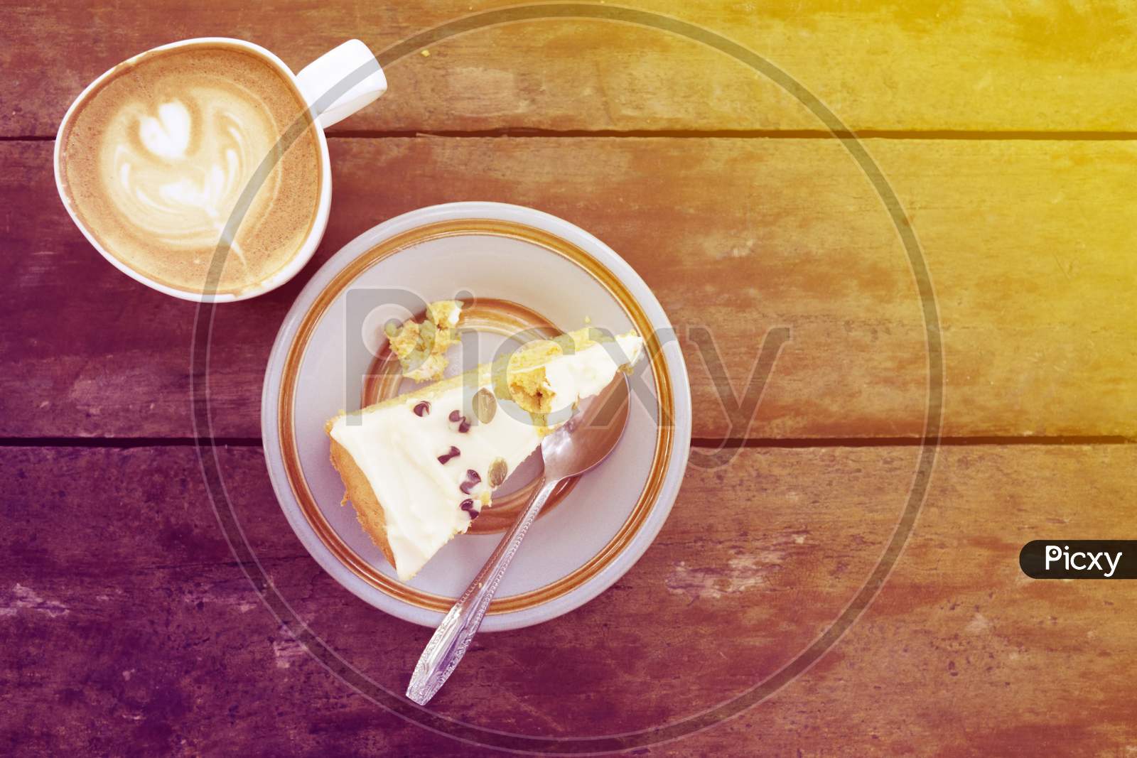 Slice Of Homemade Cake With Cup Of Latte On Wooden table