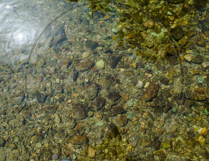 Stones under crystal clear water of  Ganga River at Rishikesh