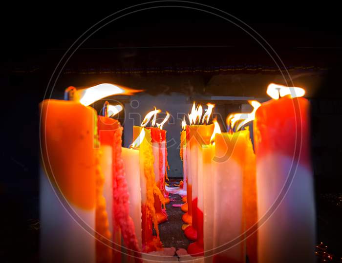 Numerous Colorful Candles Are Flaming In The Temple.