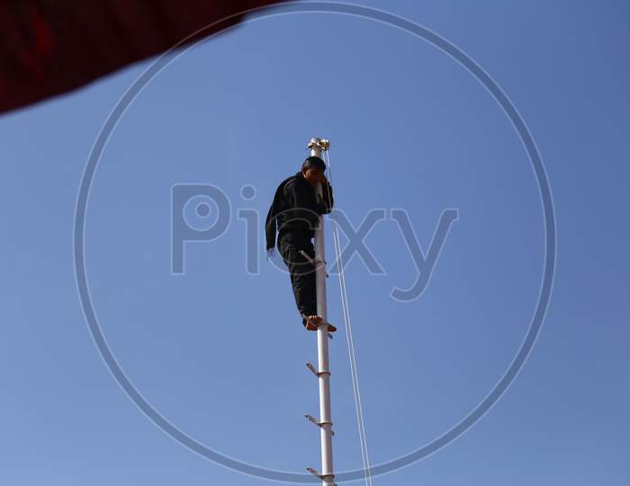 A Man Standing On Pole in Nagaur Cattle Fair