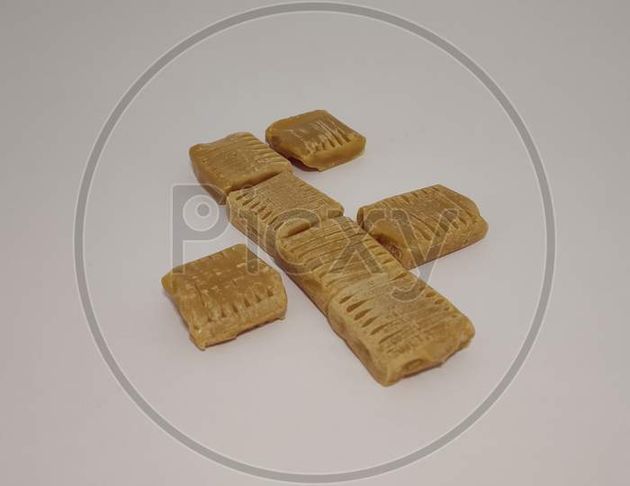 Group of dark milky chocolate cubes on white background