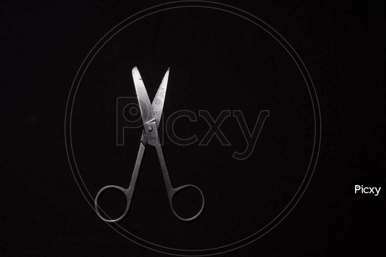 A Scissor In A Dark Copy Space Background. Product Photography.