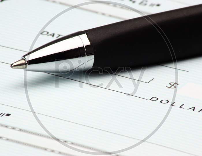 A Blank Check With Pen Closeup Representation of Invoice,Payments , Taxation, Tax Filing And  Business Transactions 