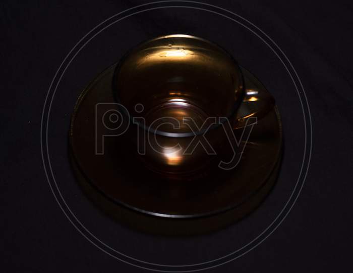 An Empty Cup And Soccer Made Of Glass In A Dark Copy Space Background. Product Photography.
