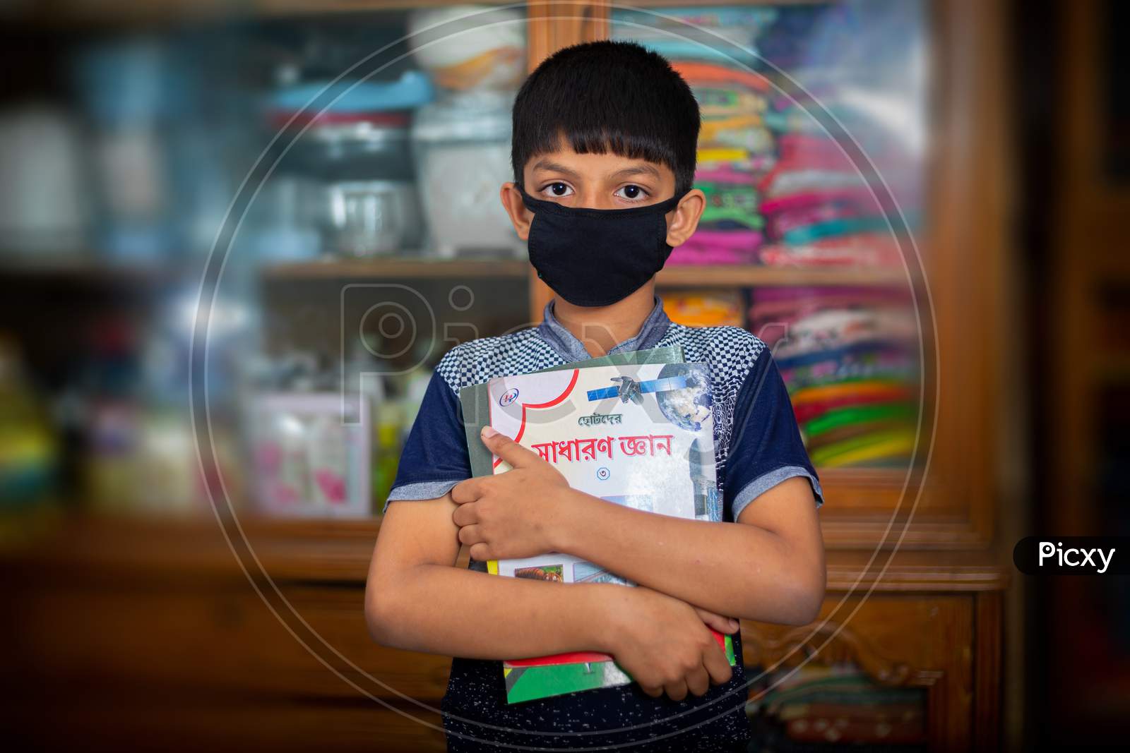 Bangladesh – April 15, 2020: A Fearful Young Boy Is Wearing A Protective Cloth Mask Against Transmissible Covid-19 Diseases And He Is Quarantined Her Home At Dhaka.
