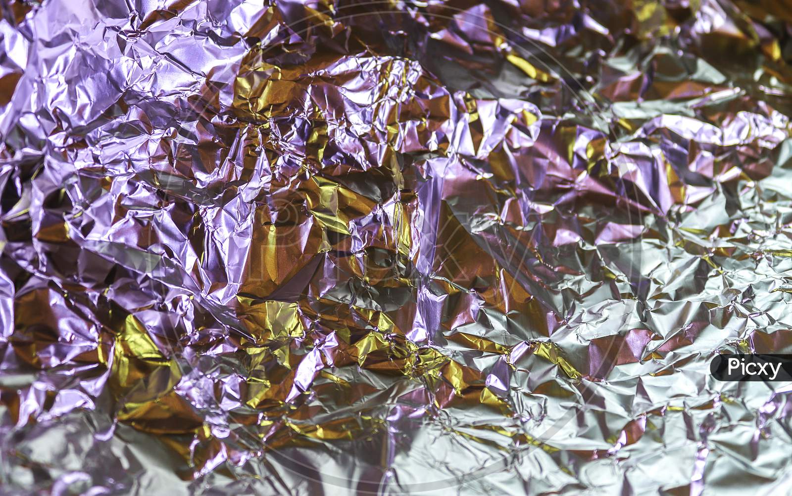 Detailed close up texture of an aluminum foil surface in different