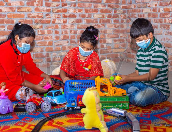 Bangladesh – April 16, 2020: In-Home Quarantine Days For Coronavirus Safety, Some Kids Are Playing With Toys And Blocks After Wearing Surgical Masks At Dhaka.