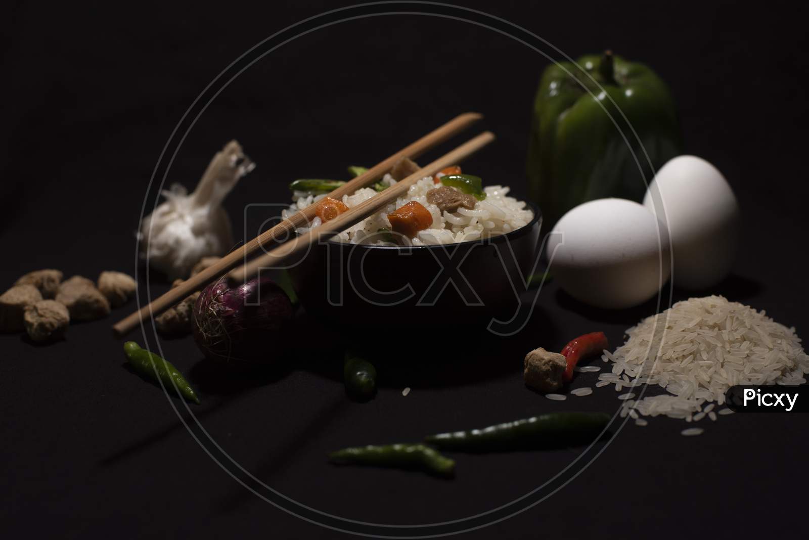 A Bowl Of A Steamed Rice And Vegetables Decorated With Veggies, Eggs, Grains, Chopsticks And Spoon In A Black Copy Space Background. Food Photography.