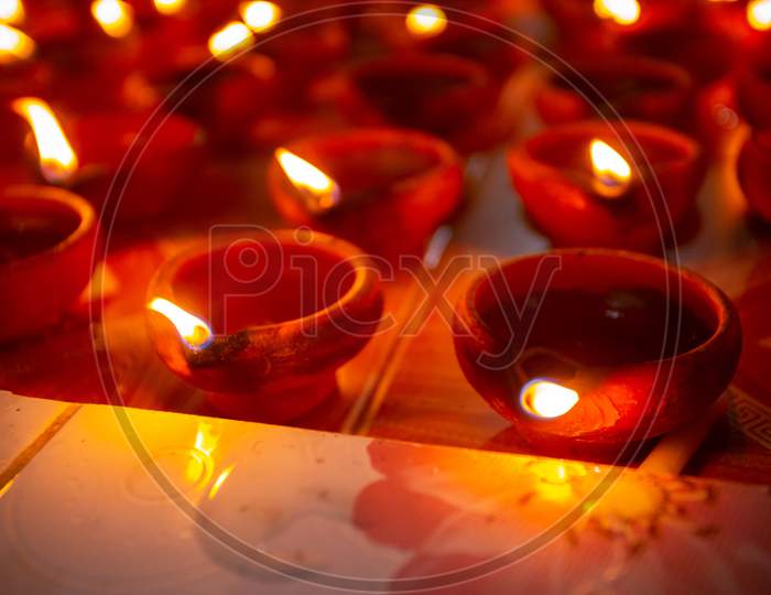 Numerous Clay Oil Lamps Are Burning. Traditional Festival Of Oil Lamp Symbolizing Spreading Of Light And End Of Darkness.