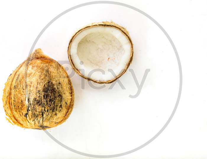 A Pealed And Cracked Coconut On Plain White Background