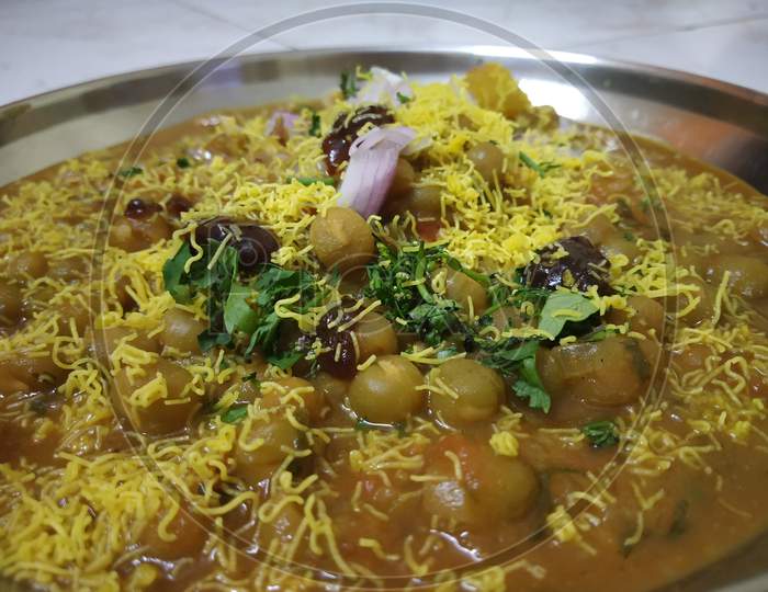 Famous Indian breakfast dish Ragda Pattice with Potato, onion, green, peace, and vegetables