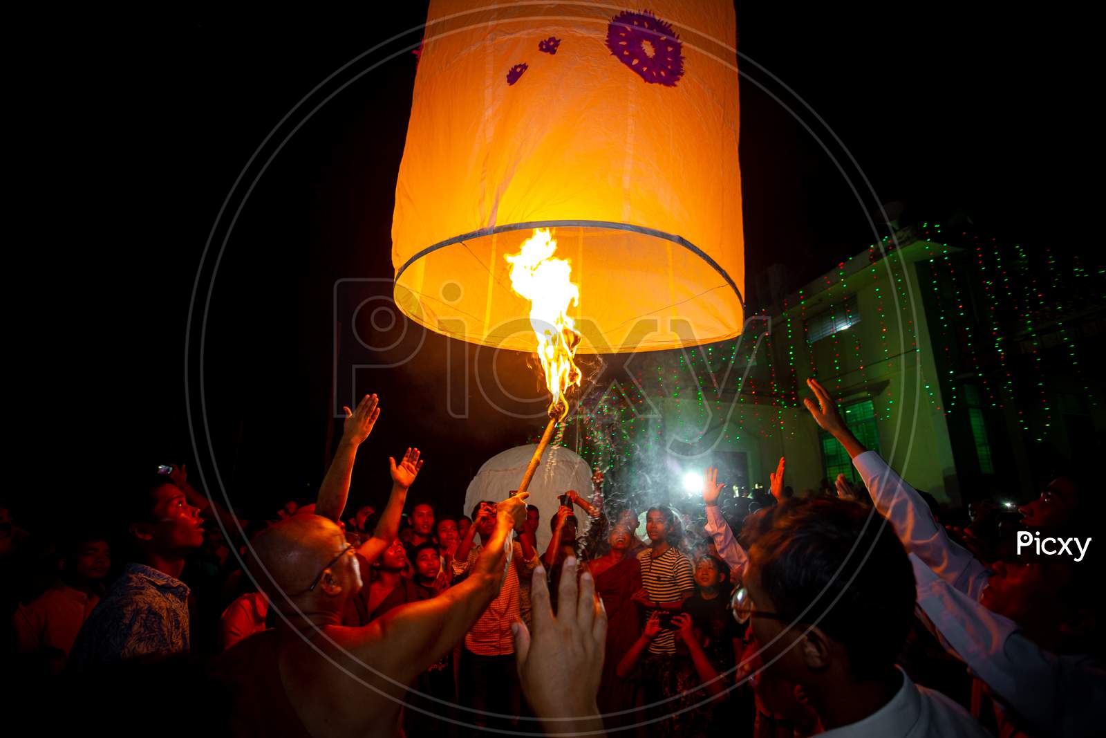 Bangladesh – October 13, 2019: A Buddhist Monk With His Disciples Trying To Fly A Paper Lantern At Ujani Para Buddhist Temple In Bandarban, Bangladesh.